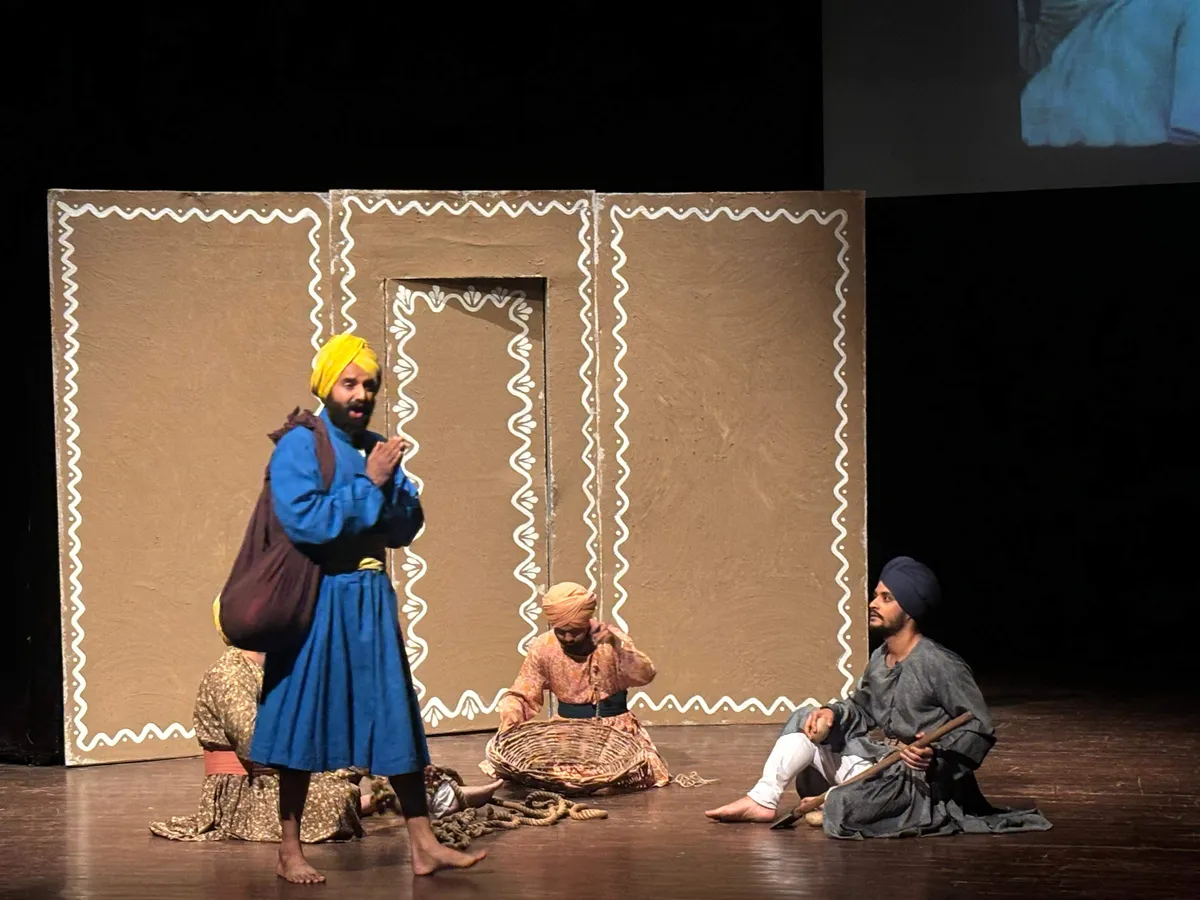 Performers in historical costume on a stage with a painted backdrop