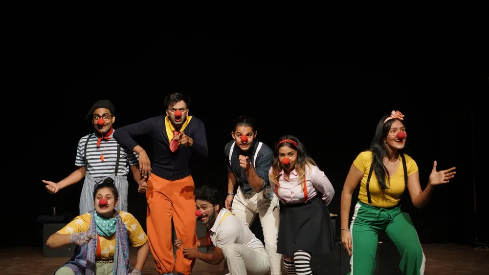The ensemble gestures towards the audience